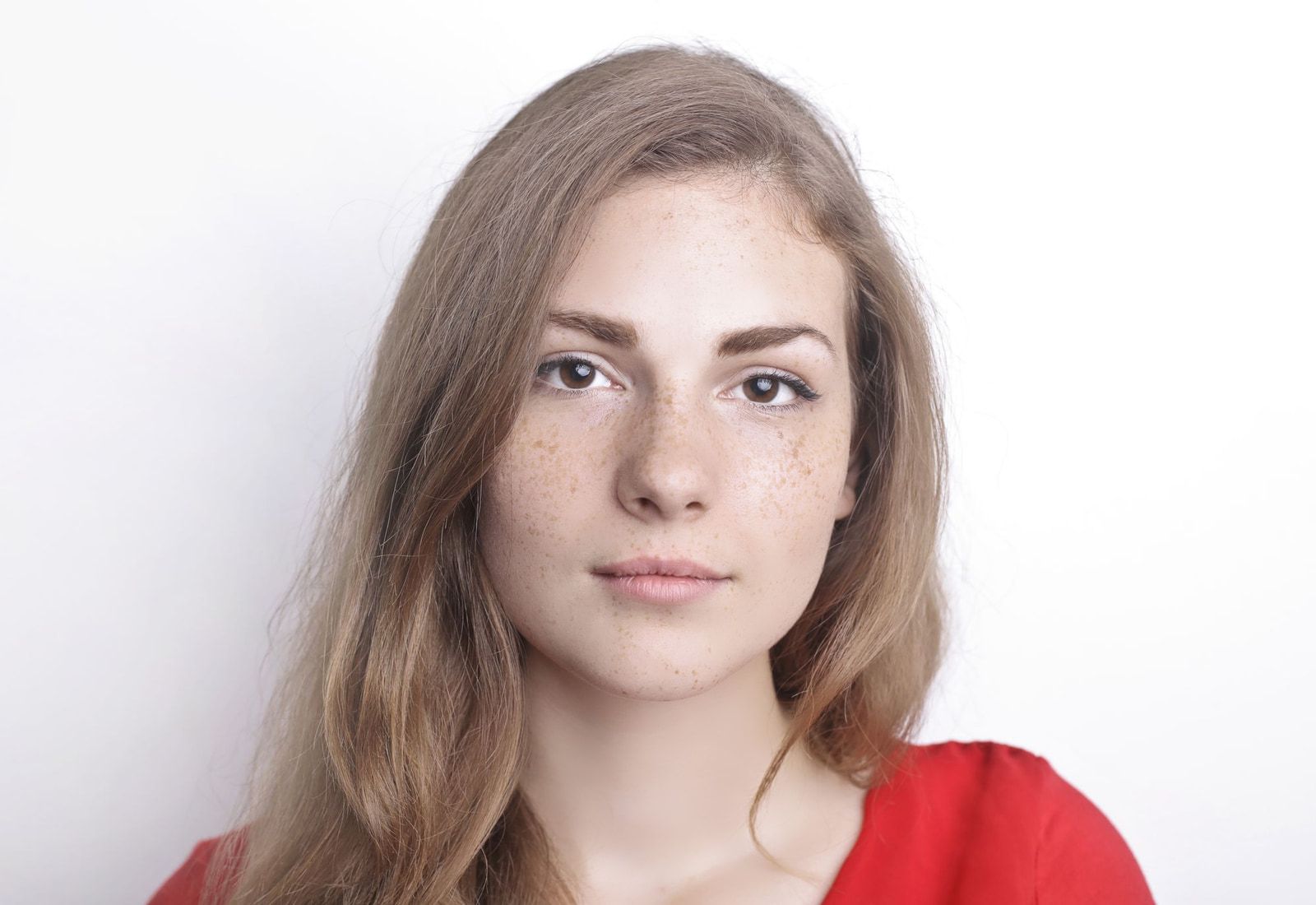 The same portrait with the smooth preset: softer skin texture, freckles faded, face shape unchanged